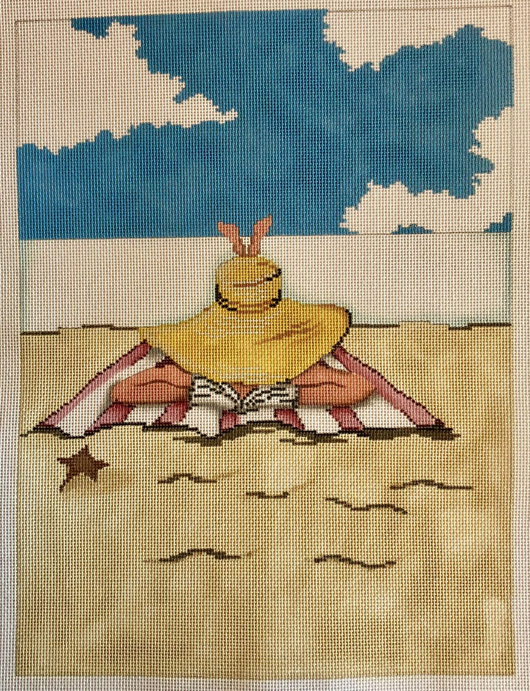 lady on beach towel reading
